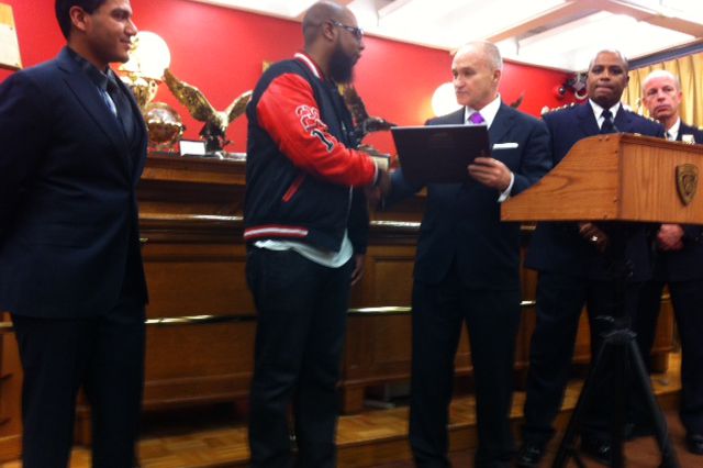 Police Commissioner Ray Kelly hands a plaque to Lawrence Abdullah.